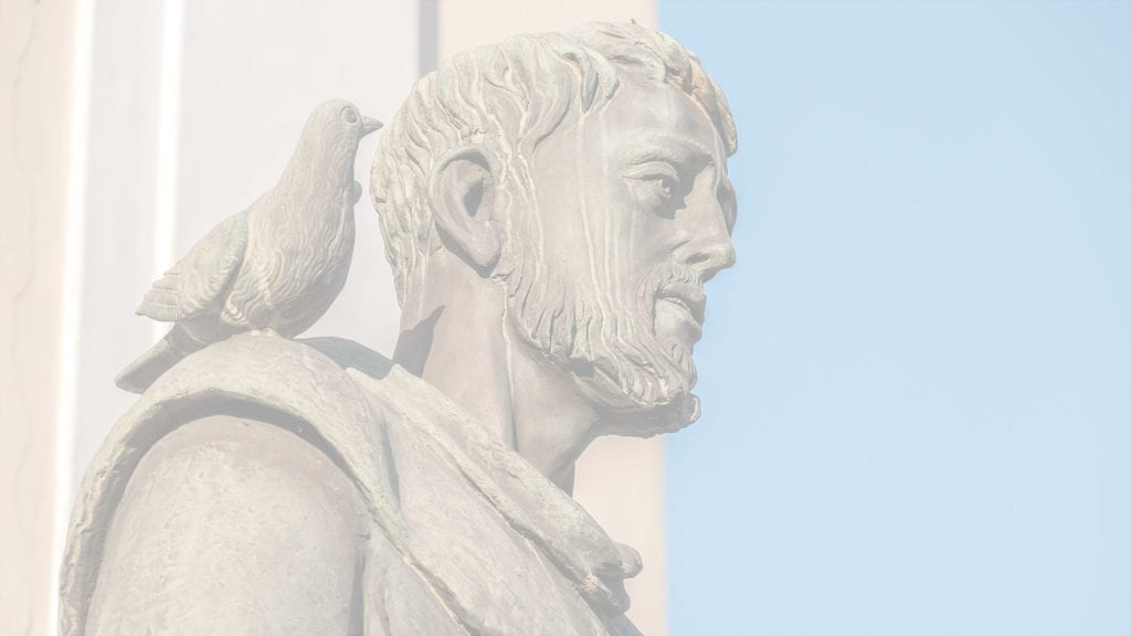 marble statue of man with a pigeon on his shoulder